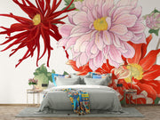 Oversized floral wall mural featuring red, pink, and yellow illustrated blooms with green leaves decorating a modern bedroom.