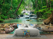 Wall mural of a lush green forest with cascading waterfalls, creating a peaceful ambiance in a modern room.