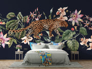 Exotic Leopard Wall Mural featuring a detailed leopard walking through lush tropical flowers and leaves on a dark background.