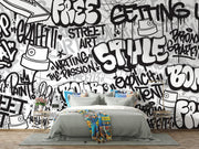 Graffiti wall mural with black-and-white street art typography and spray paint elements, ideal for urban-inspired bedrooms or creative spaces.
