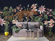 Exotic Leopard Wall Mural featuring a detailed leopard walking through lush tropical flowers and leaves on a dark background.