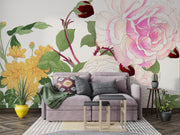 Wall mural with vintage-style pink and white roses, yellow chrysanthemums, and green foliage decorating a living room.