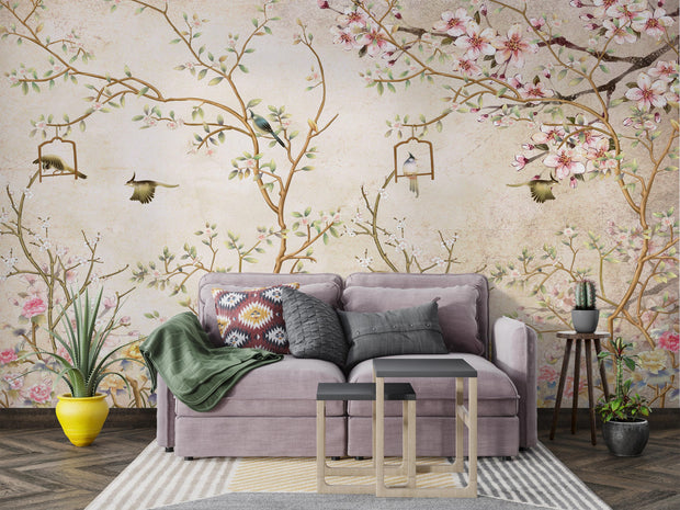 Elegant bedroom interior featuring a pastel Chinoiserie wall mural with delicate cherry blossoms and birds, decorating a living room with sofa.