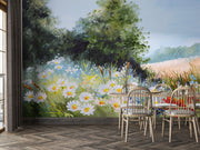 Hand-painted wall mural featuring a summer meadow with wildflowers, daisies, tall grass, and a soft blue sky, creating a peaceful countryside scene.