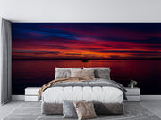 Sunset Over the Ocean Wall Mural – Stunning Seascape Wallpaper Featuring a Sailboat Silhouette, Deep Twilight Sky, and Serene Ocean Waters for Relaxing Interiors.