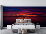 Sunset Over the Ocean Wall Mural – Stunning Seascape Wallpaper Featuring a Sailboat Silhouette, Deep Twilight Sky, and Serene Ocean Waters for Relaxing Interiors.
