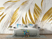 Modern abstract wall mural with golden and beige feather leaf patterns decorating a bedroom.