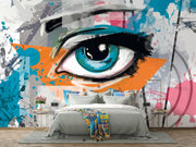 Abstract eye graffiti wall mural with bold blue eye, orange and teal splashes, and street art-inspired brushstrokes.