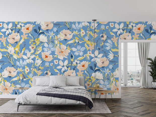 Bold botanical wall mural with vibrant blue, beige, and yellow flowers, styled in a modern bedroom.