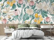 Charming floral wall mural with pink, yellow, and green flowers in a cosy bedroom.