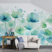 Watercolor floral wall mural featuring soft blue and green flowers in a delicate, hand-painted style, with a modern white couch and rustic decor.