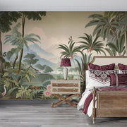 Vintage tropical landscape wall mural with exotic greenery, misty mountains, palm trees, and birds; decorating a bedroom.