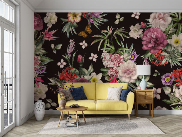 Black floral wall mural with romantic garden design behind a yellow couch in a sunlit living room.