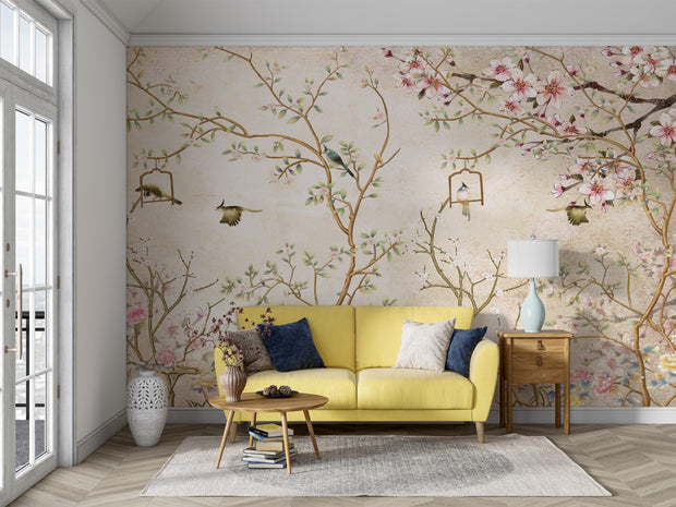 Elegant bedroom interior featuring a pastel Chinoiserie wall mural with delicate cherry blossoms and birds, decorating a living room with yellow sofa.