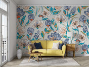 Modern artistic floral wall mural with bold blue, coral, and green flowers, styled in a bright living space with light wood furniture