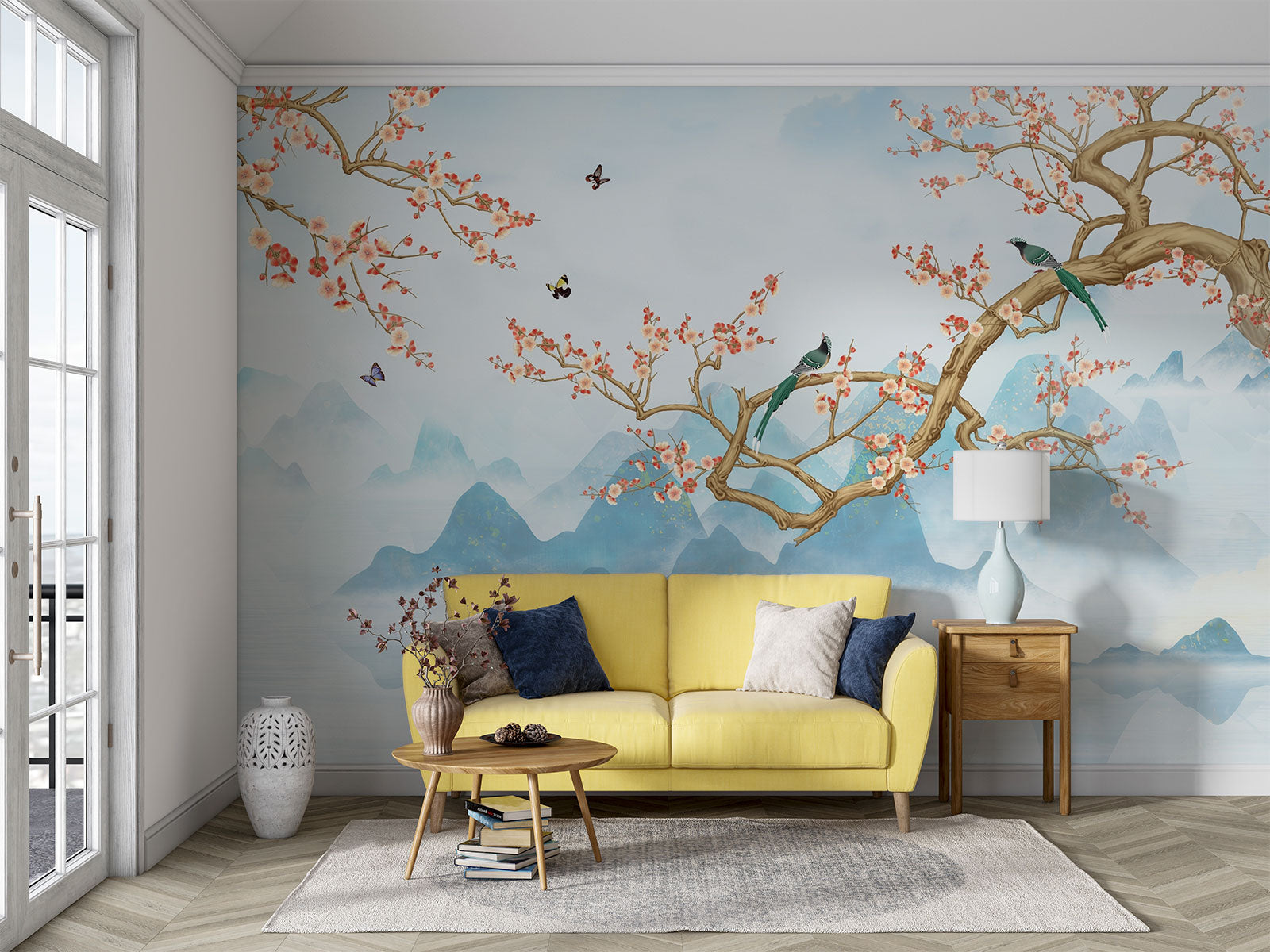 Chinoiserie-style wall mural featuring cherry blossom branches, perched birds, and misty blue mountains, creating a serene and elegant atmosphere.