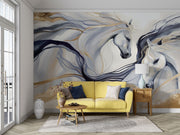 Artistic white horses wall mural featuring flowing manes, brushstroke design, and neutral beige, gold, and charcoal tones in a living room with yellow sofa.