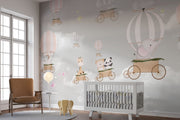 Whimsical hot air balloon animal wall mural featuring giraffes, pandas, elephants, and bears floating in the sky with soft pastel clouds – perfect for kid's rooms and nurseries.