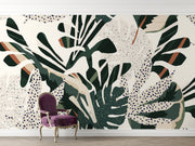 Lush foliage wall mural with bold green, beige, and rust botanical patterns and abstract dotted accents.