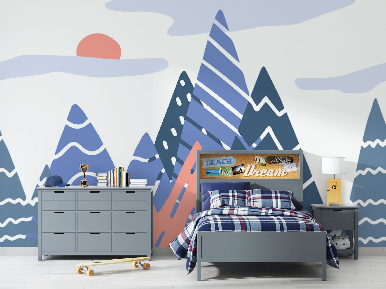 Adventure Peaks wall mural featuring abstract mountain shapes in blue and peach tones with a sun and clouds, styled in a boy’s bedroom.