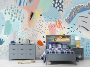 Playful abstract wall mural with colorful brushstrokes, dotted patterns, and modern art elements in a bedroom setting.