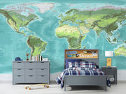 High-detail oversized world map wall mural showing terrain relief and ocean depths in turquoise and green, styled with modern furniture.