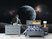 Wall mural of an astronaut sitting on the moon, gazing back at the Earth.