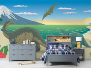 Dinosaur wall mural featuring a scenic beach with a Brachiosaurus, Triceratops, ocean waves, and a soaring Pteranodon at sunset.