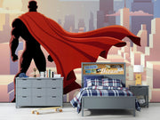 Wall mural depicting a superhero in a red cape looks over the city.
