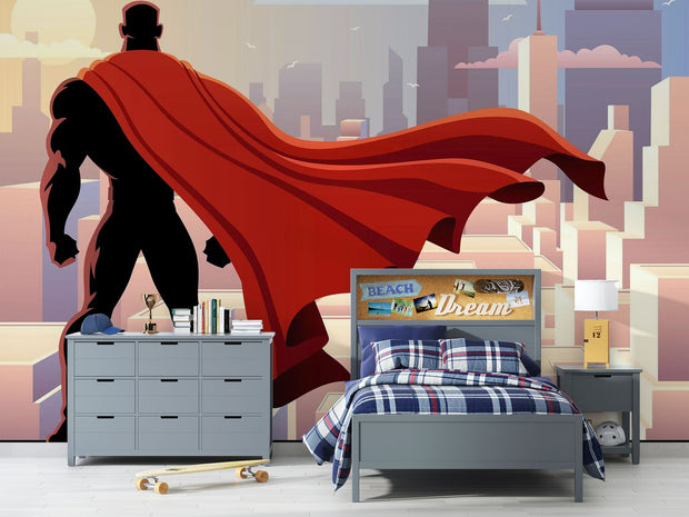 Wall mural depicting a superhero in a red cape looks over the city.