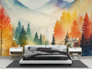 Watercolor mountain landscape wall mural with autumn forest in orange, yellow and teal, styled in modern bedroom.