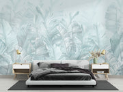 Soft blue palm leaf wall mural featuring oversized banana leaves on a light pastel background, perfect for modern interiors.