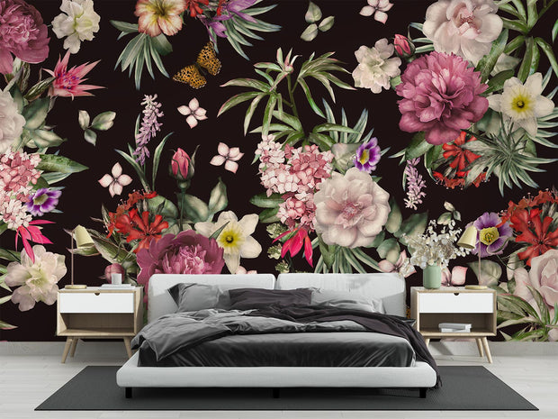Deep floral mural in a bedroom with white bed, black throw, and wood nightstands.
