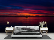 Sunset Over the Ocean Wall Mural – Stunning Seascape Wallpaper Featuring a Sailboat Silhouette, Deep Twilight Sky, and Serene Ocean Waters for Relaxing Interiors.