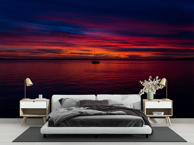 Sunset Over the Ocean Wall Mural – Stunning Seascape Wallpaper Featuring a Sailboat Silhouette, Deep Twilight Sky, and Serene Ocean Waters for Relaxing Interiors.