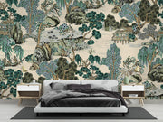 Detailed view of Chinoiserie mural showcasing hand-illustrated trees, pavilions, and serene water features in soft jade, taupe, and ivory tones; decorating a bedroom.
