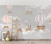 Whimsical hot air balloon animal wall mural featuring giraffes, pandas, elephants, and bears floating in the sky with soft pastel clouds – perfect for kid's rooms and nurseries.