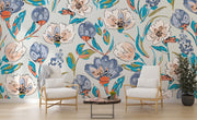 Modern artistic floral wall mural with bold blue, coral, and green flowers, styled in a bright living space with light wood furniture.