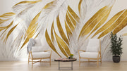 Modern abstract wall mural with golden and beige feather leaf patterns decorating a living room.