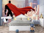 Wall mural depicting a superhero in a red cape looks over the city.