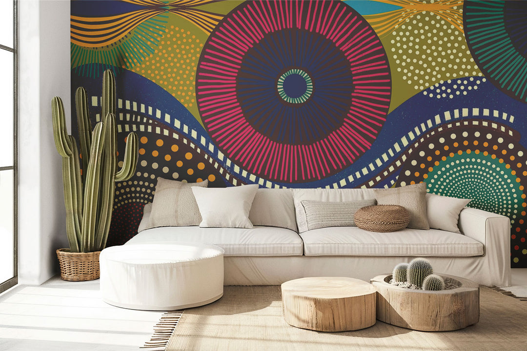 Vibrant abstract wall mural with bold geometric circular patterns, featuring bright colors and dynamic designs for modern interior decor. Styled in a living room with a sofa.