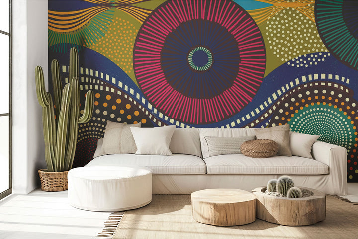 Vibrant abstract wall mural with bold geometric circular patterns, featuring bright colors and dynamic designs for modern interior decor. Styled in a living room with a sofa.