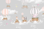 Whimsical hot air balloon animal wall mural featuring giraffes, pandas, elephants, and bears floating in the sky with soft pastel clouds – perfect for kid's rooms and nurseries.