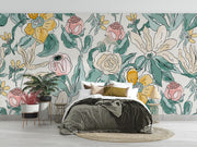 Charming floral wall mural with pink, yellow, and green flowers in a cozy bedroom.