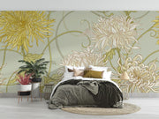 Art Nouveau floral wall mural with intricate yellow and beige chrysanthemum flowers on a sage-green background, styled in a cozy bedroom.