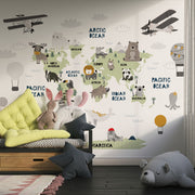Scandinavian style children's world map wall mural with cute animals and airplanes, styled in a kid's playroom.