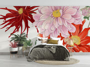 Oversized floral wall mural featuring red, pink, and yellow illustrated blooms with green leaves decorating a modern bedroom.