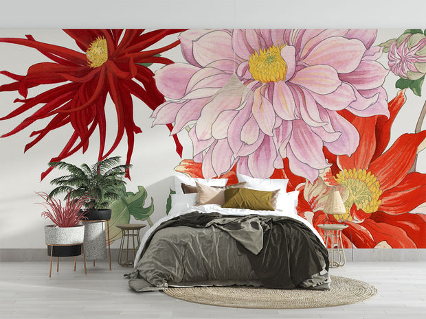 Oversized floral wall mural featuring red, pink, and yellow illustrated blooms with green leaves decorating a modern bedroom.
