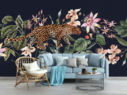 Exotic Leopard Wall Mural featuring a detailed leopard walking through lush tropical flowers and leaves on a dark background.