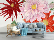 Oversized floral wall mural featuring red, pink, and yellow illustrated blooms with green leaves behind a blue modern sofa.